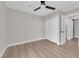 Cozy bedroom with wood floors, ceiling fan, and a closet provides a comfortable and practical living space at 1611 Buffalo Trail Dr, Henderson, NV 89014