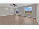 Bright bedroom showcasing large windows with views and wood-look flooring at 1611 Buffalo Trail Dr, Henderson, NV 89014