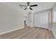 This bedroom features a ceiling fan, wood flooring and closet storage space at 1611 Buffalo Trail Dr, Henderson, NV 89014