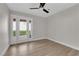 Empty bedroom with wood-look floors, ceiling fan, and french doors to the backyard at 1611 Buffalo Trail Dr, Henderson, NV 89014