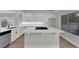 Eat-in kitchen with white cabinetry and island with gas stovetop at 1611 Buffalo Trail Dr, Henderson, NV 89014