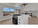 Kitchen with stainless cooktop on island with views of the landscaped backyard at 1611 Buffalo Trail Dr, Henderson, NV 89014
