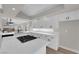 Bright kitchen showcasing an island with cooktop and white cabinets with quartz countertops at 1611 Buffalo Trail Dr, Henderson, NV 89014