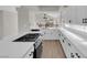 Bright kitchen featuring stainless appliances and white cabinets with quartz countertops and hardwood floors at 1611 Buffalo Trail Dr, Henderson, NV 89014