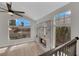 Bright living room with hardwood floors, fireplace, large windows offering scenic views, and a ceiling fan at 1611 Buffalo Trail Dr, Henderson, NV 89014