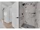 Luxurious walk-in shower features marble tiling, modern fixtures, and a sleek design for a spa-like experience at 1611 Buffalo Trail Dr, Henderson, NV 89014