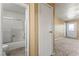 View of the home's bathroom with a tub and shower combination next to the bedroom with carpeted floors at 1628 Justin Ct # 18, Henderson, NV 89011