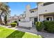 Charming townhouse with a private courtyard, lush lawn, and mature trees creating curb appeal at 1628 Justin Ct # 18, Henderson, NV 89011