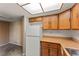 The kitchen features wood cabinetry, white appliances, and direct access to the adjacent living space at 1628 Justin Ct # 18, Henderson, NV 89011
