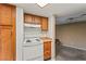 The kitchen features wood cabinetry, a white range, and direct access to the adjacent living space at 1628 Justin Ct # 18, Henderson, NV 89011