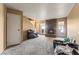 Cozy living room with stone fireplace, carpet, and bright natural light at 1628 Justin Ct # 18, Henderson, NV 89011