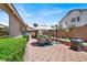 A spacious backyard includes an outdoor seating area, greenery, and easy access to outdoor cooking at 1763 Crystal Stream Ave, Henderson, NV 89012