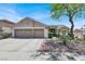 Charming single-story home featuring a well-manicured yard, two-car garage, and desert landscaping at 1763 Crystal Stream Ave, Henderson, NV 89012