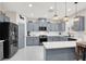The kitchen features gray cabinetry, stainless steel appliances, and unique pendant lighting at 1763 Crystal Stream Ave, Henderson, NV 89012