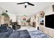 Spacious open-concept living area with modern furnishings and seamless transition to dining area at 1763 Crystal Stream Ave, Henderson, NV 89012