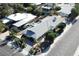 Aerial view of the property featuring a gray roof, mature trees, well-maintained landscaping, and a convenient neighborhood at 1819 Beverly Way, Las Vegas, NV 89104
