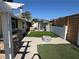 Spacious backyard with an outdoor kitchen, a fire pit, and artificial grass at 1819 Beverly Way, Las Vegas, NV 89104