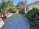 Inviting paver driveway with mature landscaping, creating a serene pathway to the home's entrance at 1819 Beverly Way, Las Vegas, NV 89104