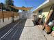 Long driveway made of pavers leading to the entrance gate under a sunshade at 1819 Beverly Way, Las Vegas, NV 89104