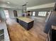 Well-appointed kitchen with a large island, granite countertops, stainless steel appliances, and wood-look flooring at 1819 Beverly Way, Las Vegas, NV 89104