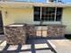 Well-equipped outdoor kitchen area featuring stone accents and modern appliances at 1819 Beverly Way, Las Vegas, NV 89104