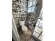 Unique powder room with patterned wallpaper and tiled flooring at 1819 Beverly Way, Las Vegas, NV 89104