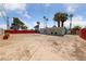 Spacious backyard under a blue sky with scattered mature trees, ample space for customization at 1828 Golden Arrow Dr, Las Vegas, NV 89169
