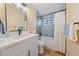 Updated bathroom showcasing a modern vanity, stylish fixtures, and tiled tub at 1828 Golden Arrow Dr, Las Vegas, NV 89169
