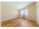 A bright bedroom featuring wood-look floors, neutral walls, and a window at 1828 Golden Arrow Dr, Las Vegas, NV 89169