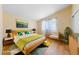 This staged bedroom has wood-look floors and a cozy, cheerful vibe at 1828 Golden Arrow Dr, Las Vegas, NV 89169