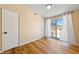 Bright bedroom with a sliding glass door, modern lighting, and neutral walls at 1828 Golden Arrow Dr, Las Vegas, NV 89169