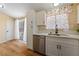 Bright kitchen with white cabinets, stainless steel appliances, and a window overlooking the yard at 1828 Golden Arrow Dr, Las Vegas, NV 89169