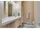 Bright bathroom with a long countertop, single sink, decorative shark rug, and tan colored walls at 2090 Eaglepath Cir, Henderson, NV 89074