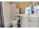 Bathroom featuring a tub/shower combo with white tiles and a vanity with bright cabinets at 2090 Eaglepath Cir, Henderson, NV 89074