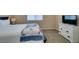 Cozy bedroom showcasing a comfortable bed, dresser, and natural light at 2090 Eaglepath Cir, Henderson, NV 89074