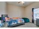 Cozy bedroom with a basketball themed bedding, a gray dresser, and a comfortable green beanbag chair at 2090 Eaglepath Cir, Henderson, NV 89074