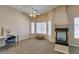 Spacious main bedroom with vaulted ceiling, bright windows, a decorative fireplace, and tan walls at 2090 Eaglepath Cir, Henderson, NV 89074