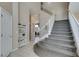 Inviting home foyer featuring tile floors, a staircase with carpeted steps, and a charming built-in bookcase at 2090 Eaglepath Cir, Henderson, NV 89074