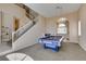 Open floor plan with a pool table, chandelier, and staircase at 2090 Eaglepath Cir, Henderson, NV 89074