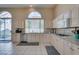 Charming kitchen with light wood cabinets, granite counters, and stainless steel dishwasher at 2090 Eaglepath Cir, Henderson, NV 89074