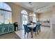 Bright kitchen and dining area with tiled floors, stainless steel appliances, and modern finishes at 2090 Eaglepath Cir, Henderson, NV 89074