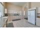 Bright kitchen showcasing light wood cabinetry, granite countertops, and tile flooring at 2090 Eaglepath Cir, Henderson, NV 89074