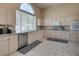 Spacious kitchen featuring light wood cabinets, granite countertops, and stainless steel appliances at 2090 Eaglepath Cir, Henderson, NV 89074