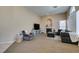 Open living room showcasing a fireplace, neutral colors, and large windows at 2090 Eaglepath Cir, Henderson, NV 89074