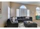 Spacious living room with large windows, a sectional sofa, and stylish decor at 2090 Eaglepath Cir, Henderson, NV 89074