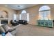 Spacious living room featuring a cozy fireplace and large windows at 2090 Eaglepath Cir, Henderson, NV 89074