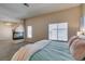 Bright main bedroom boasts a fireplace, ceiling fan, and large window, offering a relaxing retreat at 2090 Eaglepath Cir, Henderson, NV 89074