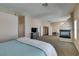 Spacious main bedroom with fireplace and natural light, with a TV and ensuite bathroom at 2090 Eaglepath Cir, Henderson, NV 89074