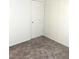 A simple bedroom with neutral carpet and white door at 2110 Los Feliz St # 2037, Las Vegas, NV 89156