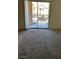 Bedroom featuring neutral walls, carpeted floors, and natural light from a sliding glass door at 2110 Los Feliz St # 2037, Las Vegas, NV 89156